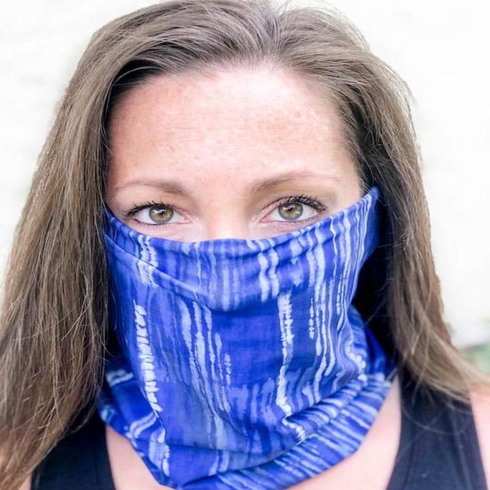 Adult woman wearing a blue dreams pattern face cover by Jolina Boutique