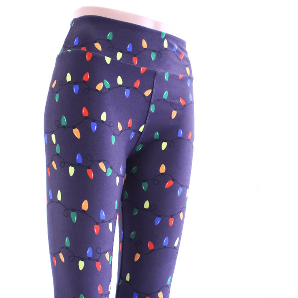 Blue Christmas leggings shown with a Christmas lights pattern wrapping around the legs