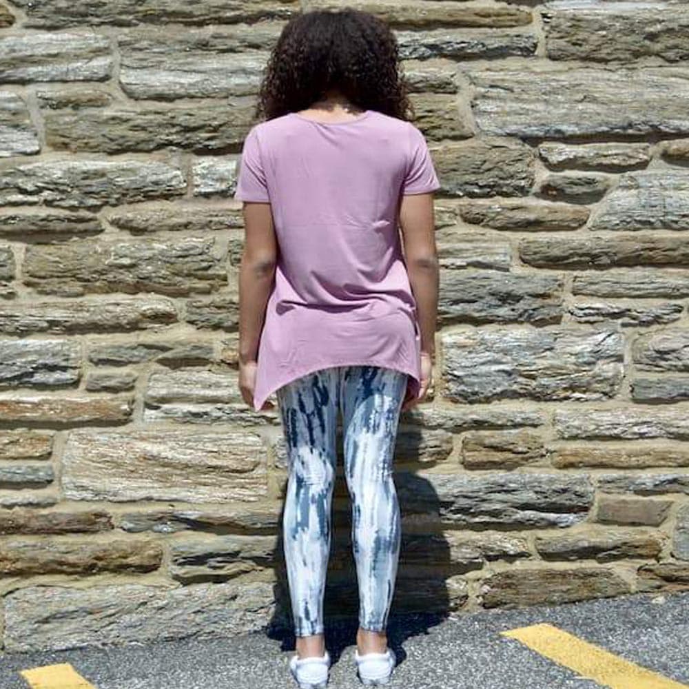 Model showing the back view of her gray haze pattern leggings by Jolina Boutique