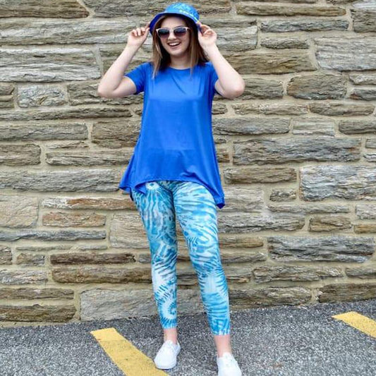 Model shown laughing and posing with laguna breeze pattern leggings sold by Jolina Boutique