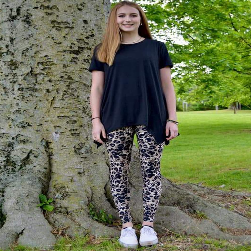 Model showing the front view of her leopard pattern leggings sold by Jolina Boutique