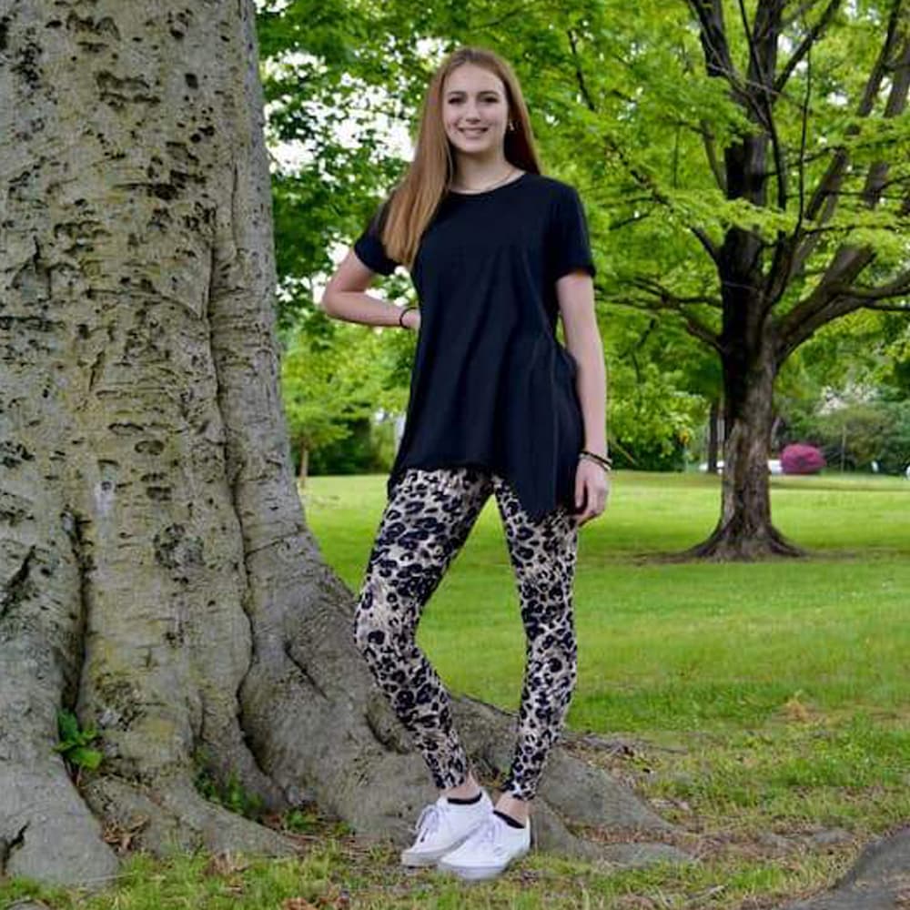 Girl posing in leopard pattern leggings for women sold by Jolina Boutique