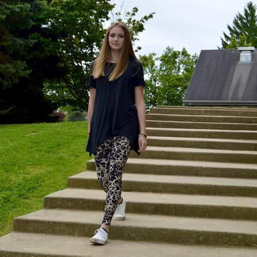 Model shown walking while wearing leopard pattern leggings sold by Jolina Boutique