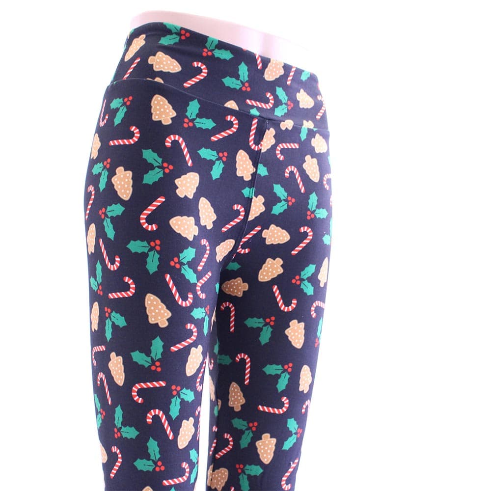 Tis the season Christmas leggings are black with colorful patterns of candy canes, mistletoes, and ginger cookies