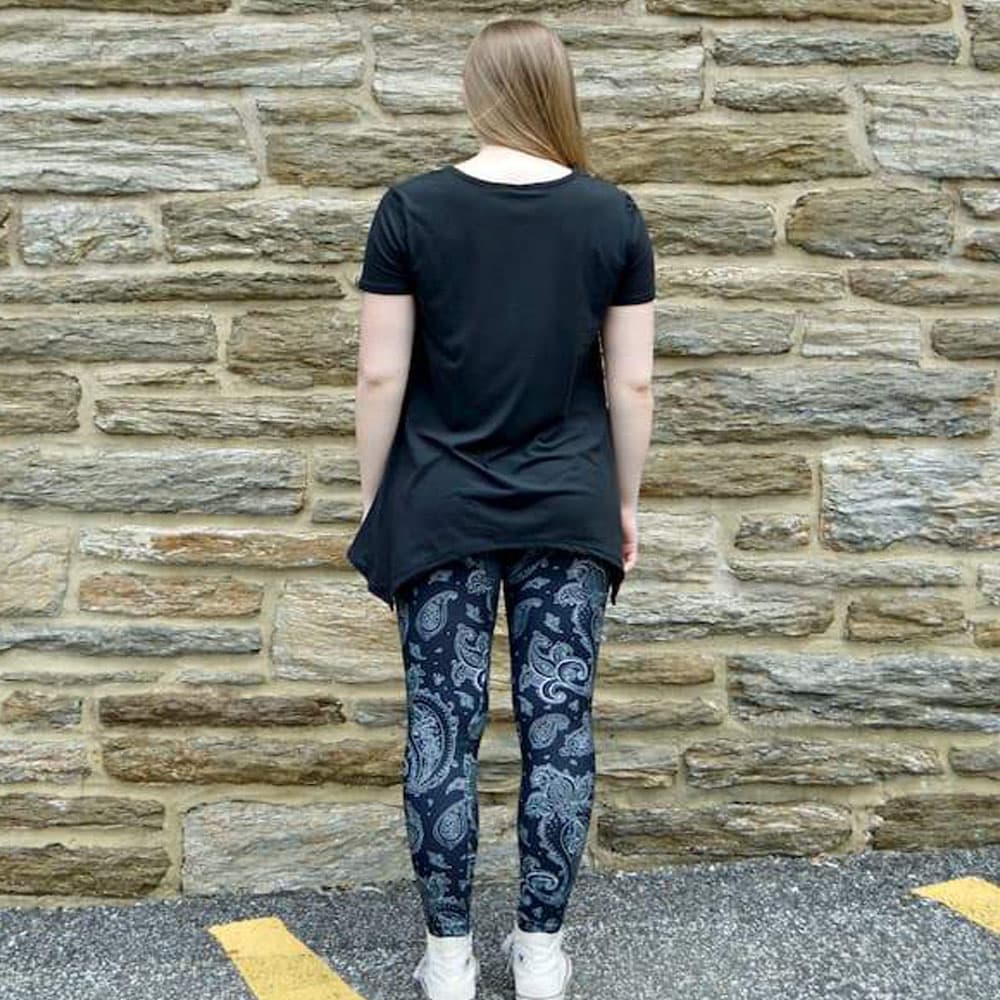Model showing back view of black paisley pattern leggings by Jolina Boutique
