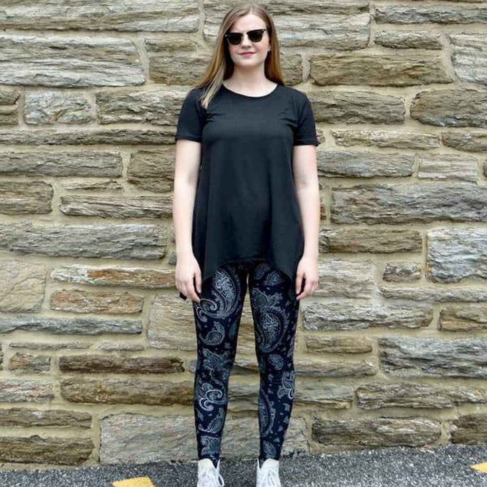 Model showing front view of black paisley pattern leggings sold by Jolina Boutique