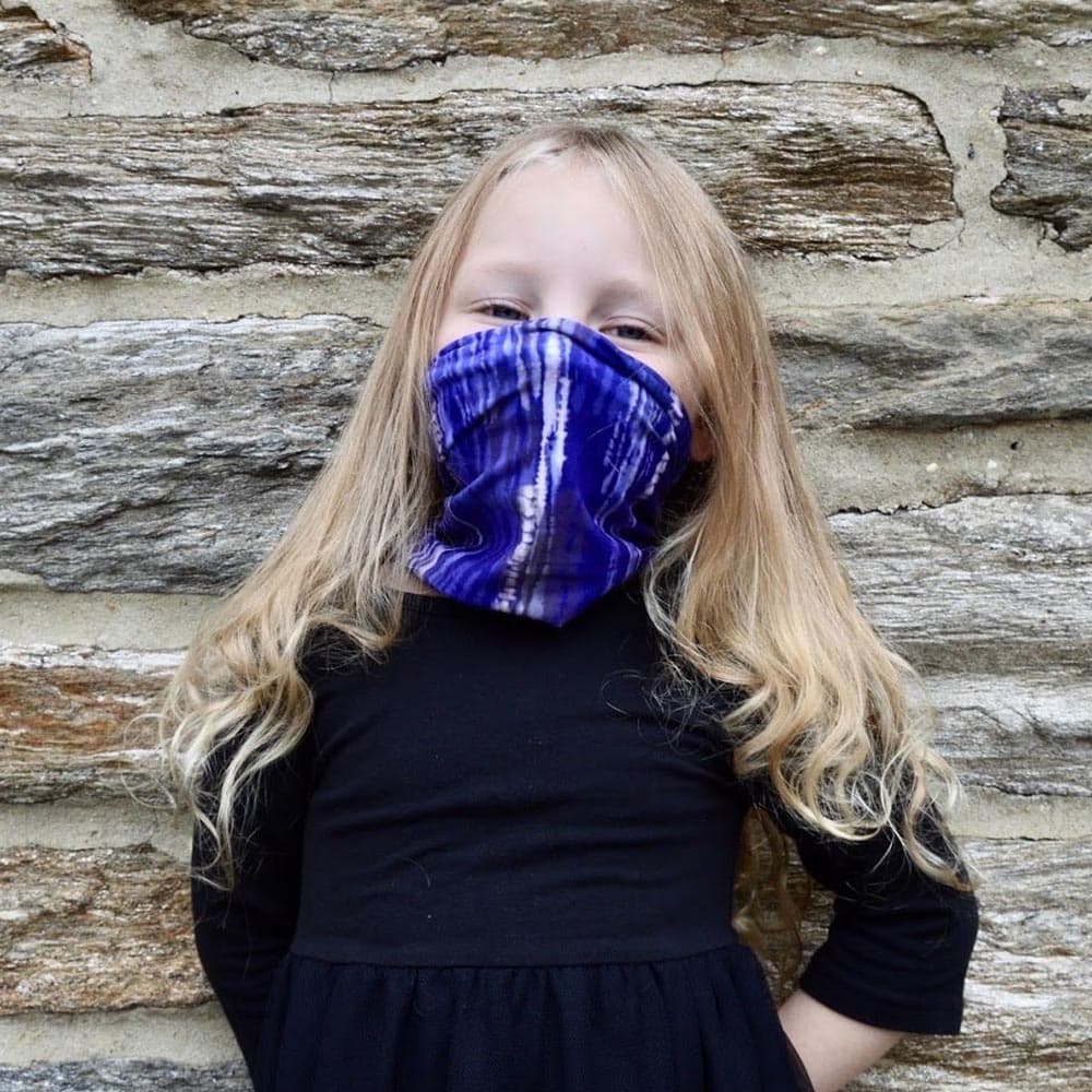 A kid female wearing a blue dreams face cover by Jolina Boutique
