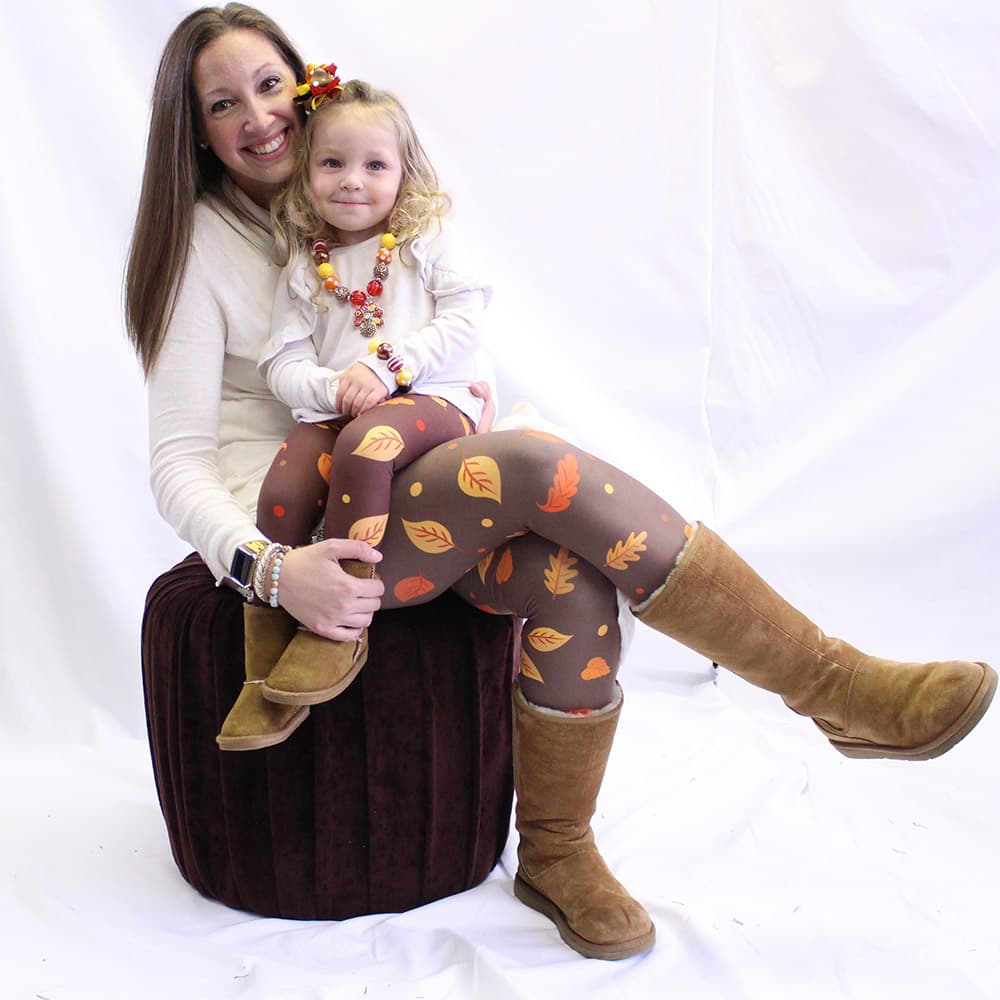 Mother and daughter wearing Autumn themed leggings by Jolina Boutique
