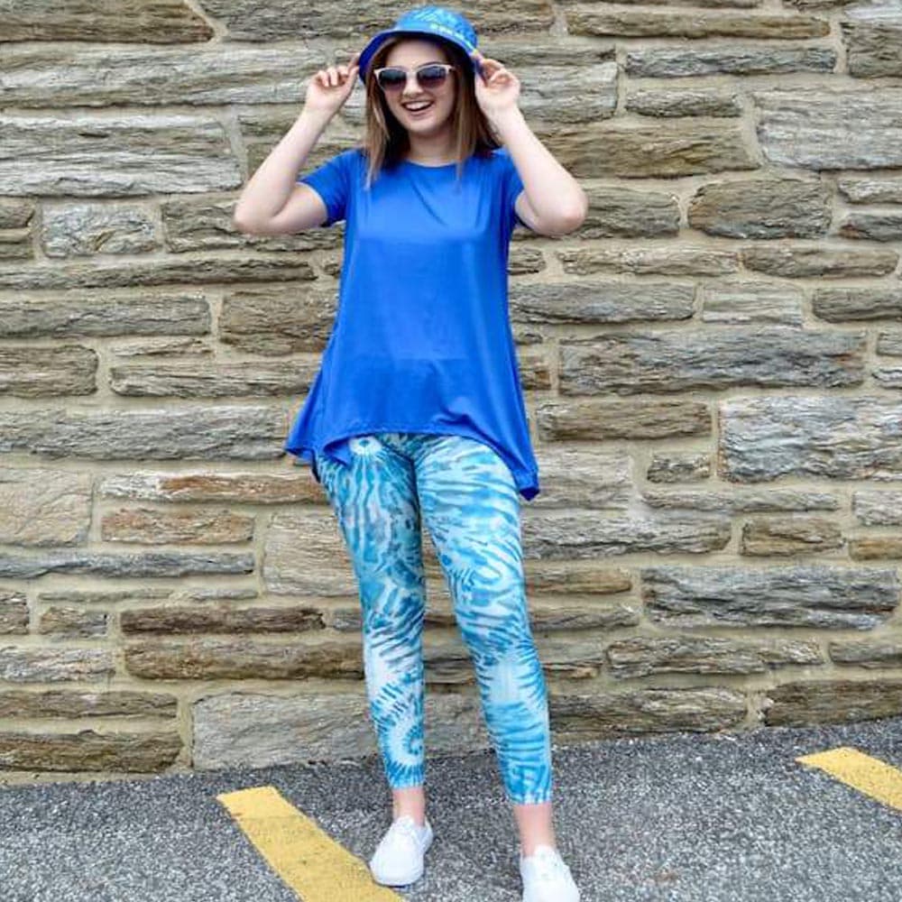 Model shown laughing and posing with laguna breeze pattern leggings sold by Jolina Boutique