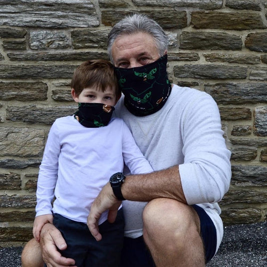 Philadelphia football bleed green face covers worn by an adult and kid