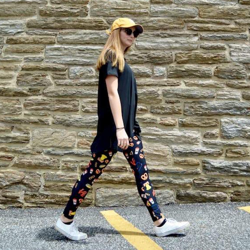 Model walking wearing Philly LOVE pattern leggings by Jolina Boutique